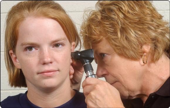 Figure 19.9 Ear examination using an otoscope.
